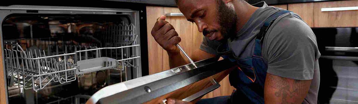 Repairman fixing a dishwasher.