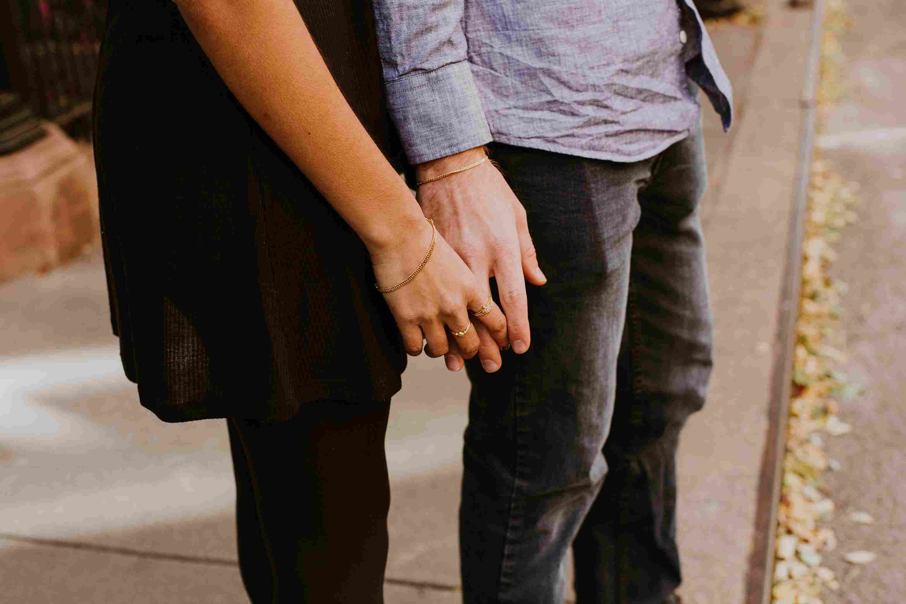 Male's and female's hands holding each other.