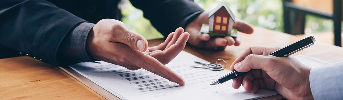 Person signing a real esate deed.